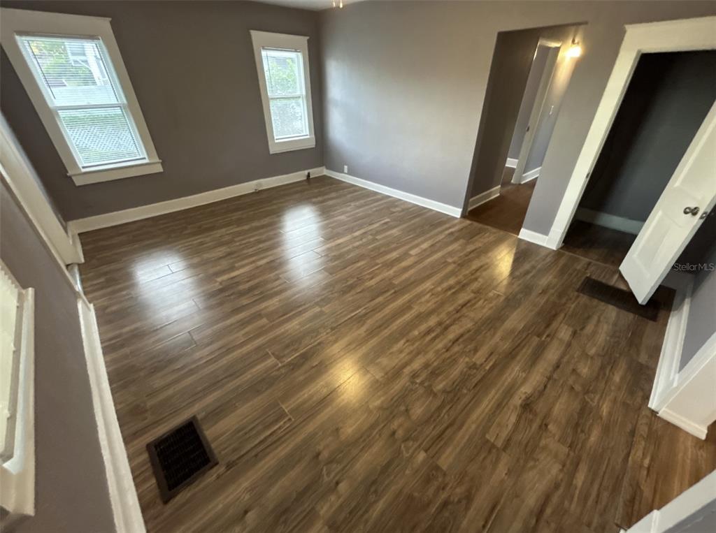 620 5th Avenue West, Unit A DOWNSTAIRS Palmetto, FL 34221 - Photo 5 of 13 an empty room with wooden floor and windows