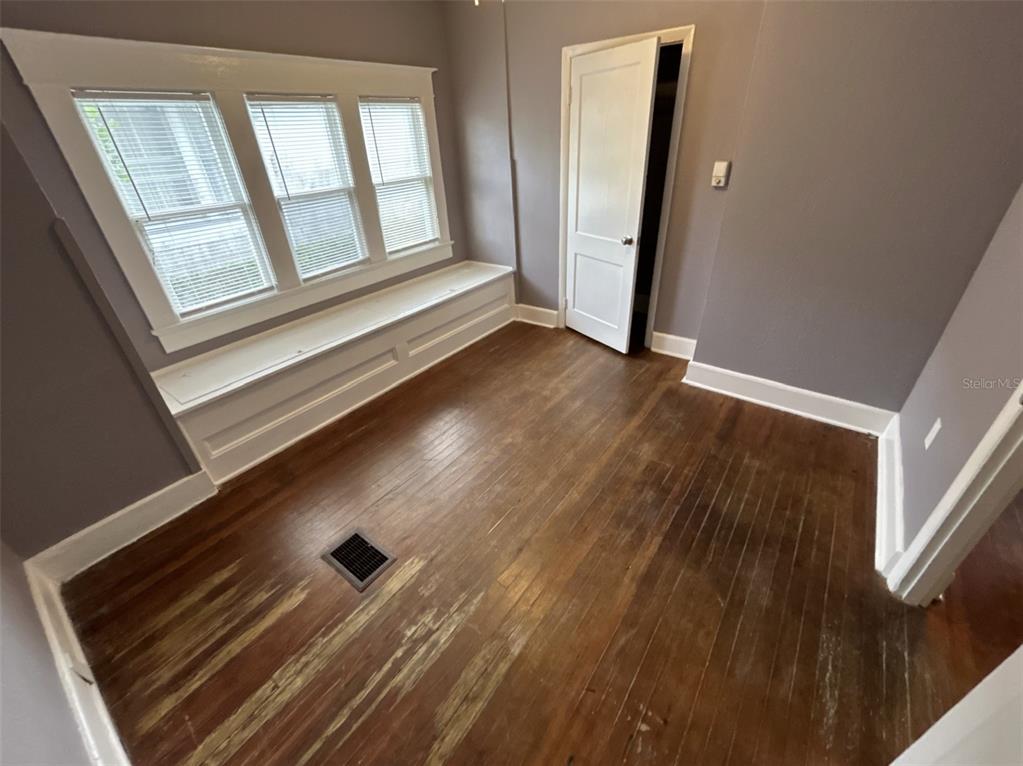 620 5th Avenue West, Unit A DOWNSTAIRS Palmetto, FL 34221 - Photo 6 of 13 a view of an empty room with wooden floor and a window
