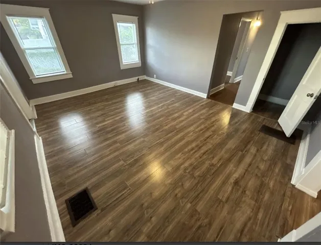 a view of an empty room with a fireplace and a floor to ceiling window