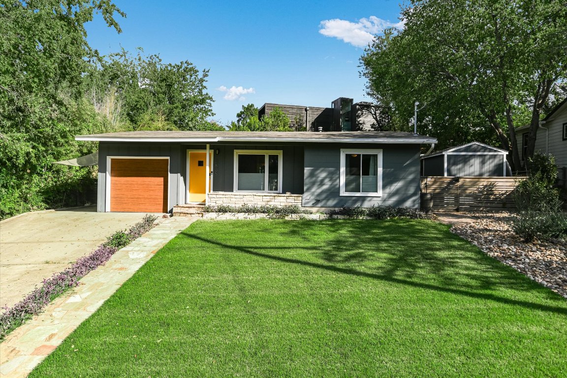 a front view of house with a garden and patio