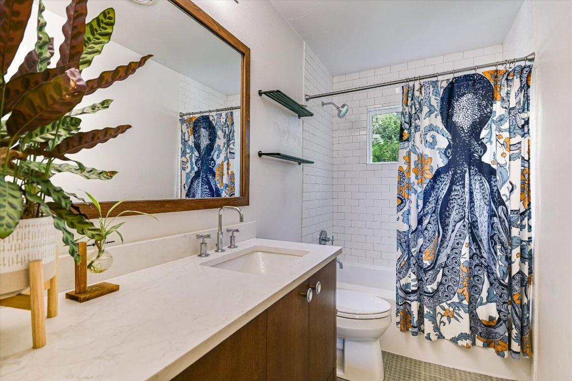 2805 South 5th Street Austin, TX 78704 - Photo 15 of 25 a bathroom with a sink a toilet and a mirror