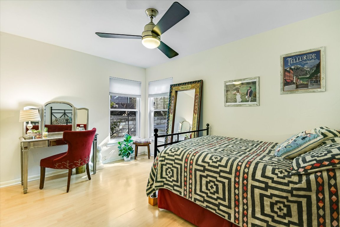 2805 South 5th Street Austin, TX 78704 - Photo 16 of 25 a bed sitting in a spacious bedroom next to a window and a chandelier