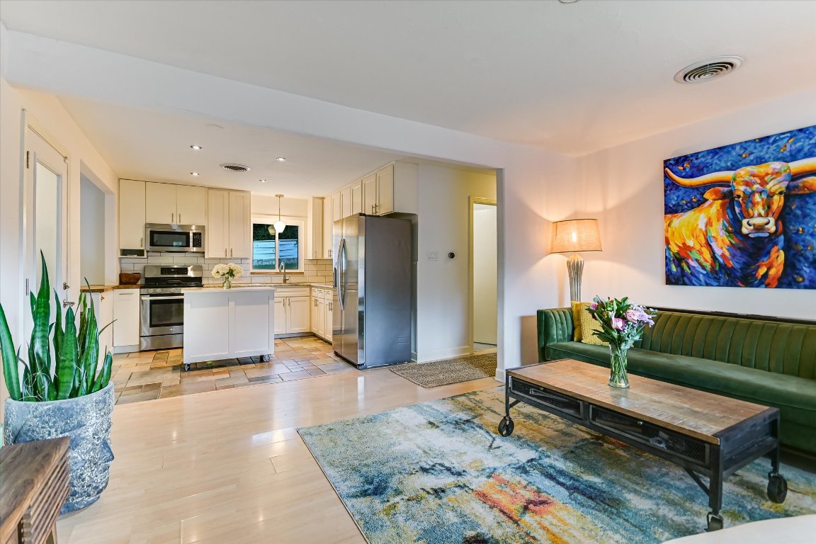 2805 South 5th Street Austin, TX 78704 - Photo 6 of 25 a living room with stainless steel appliances furniture a rug and a kitchen view