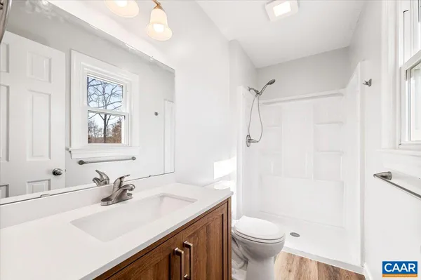 a bathroom with a sink toilet and shower
