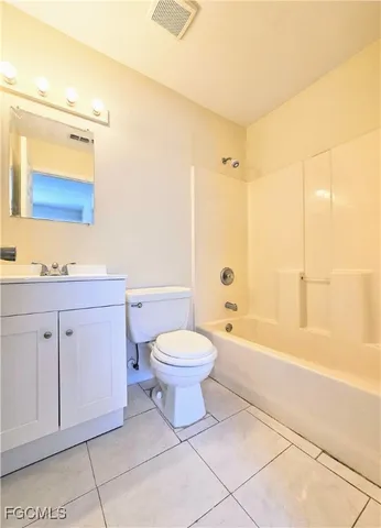 a bathroom with a bathtub toilet sink vanity and mirror
