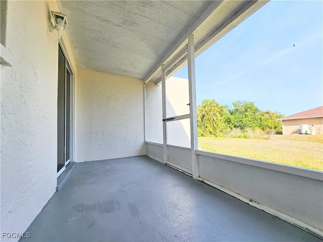 a view of an empty room and a window
