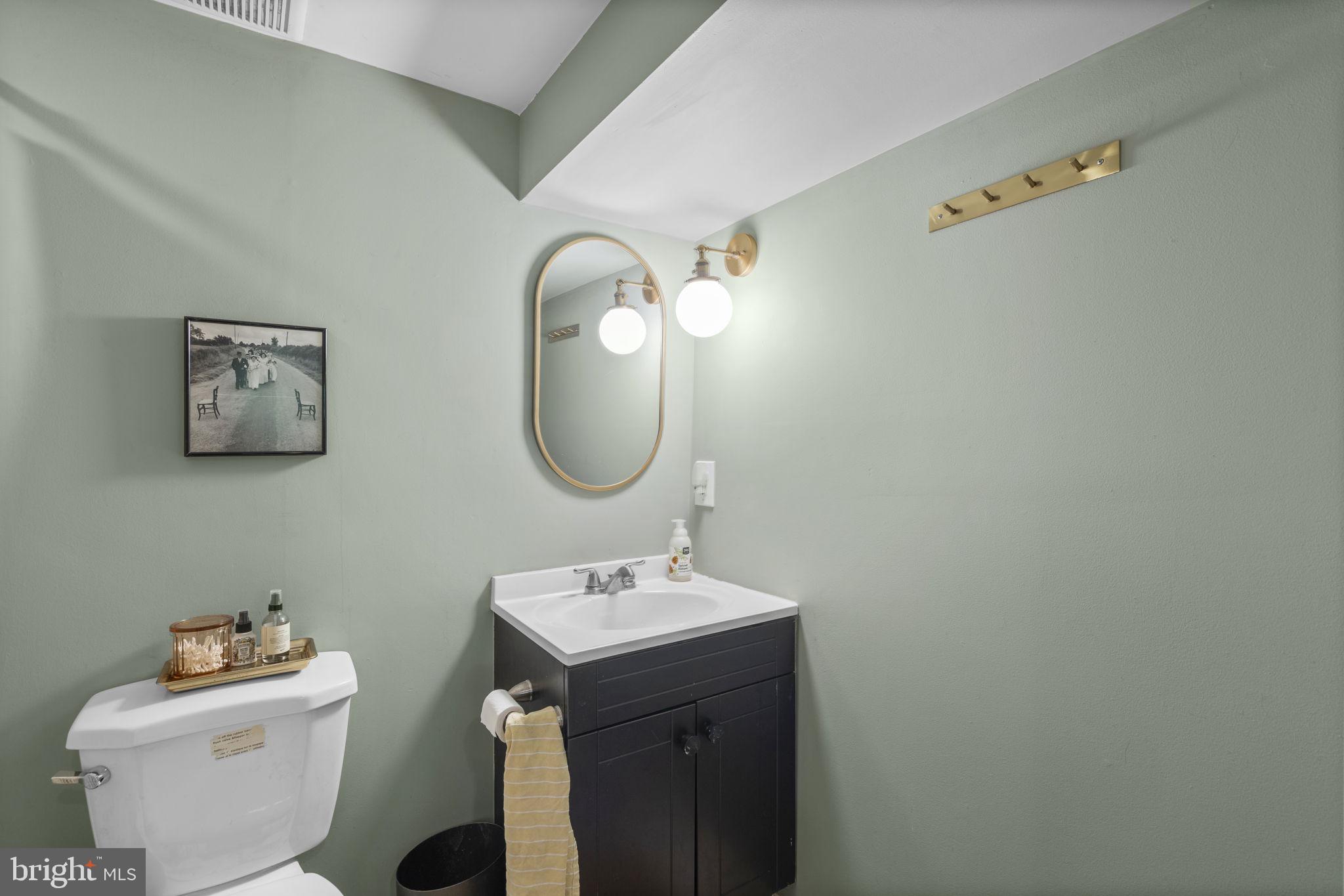 1712 M Street Northeast Washington, DC 20002 - Photo 27 of 38 a bathroom with a sink mirror and toilet