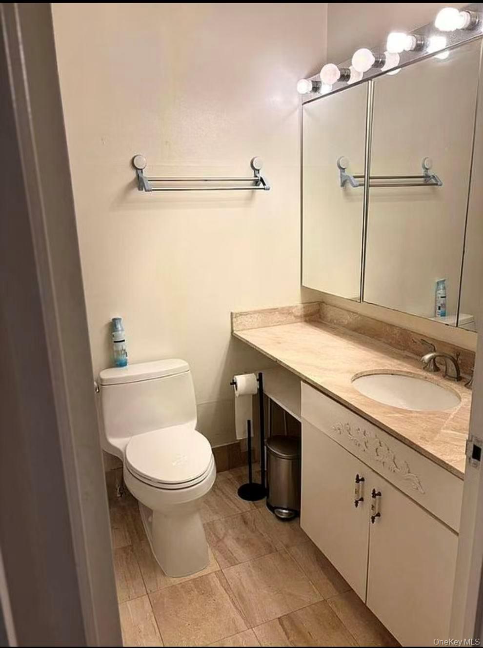 145 East 48th Street, Unit 22C Manhattan, NY 10017 - Photo 3 of 11 a bathroom with a granite countertop sink toilet and shower
