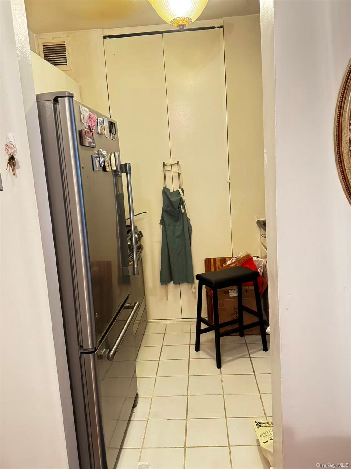 145 East 48th Street, Unit 22C Manhattan, NY 10017 - Photo 10 of 11 a view of a hallway with furniture and refrigerator