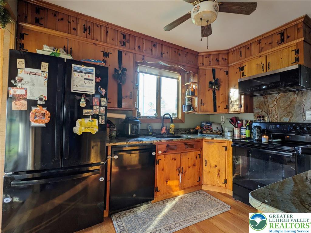 538 Belfast Road Nazareth, PA 18064 - Photo 14 of 25 a kitchen with stainless steel appliances granite countertop a sink a stove and a wooden floors