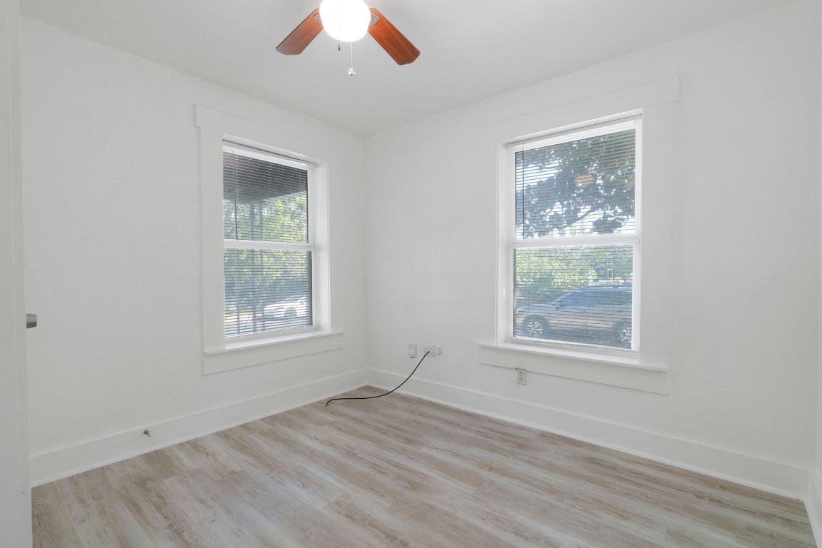 1606 Maple Avenue Austin, TX 78702 - Photo 11 of 15 an empty room with wooden floor cabinet and windows