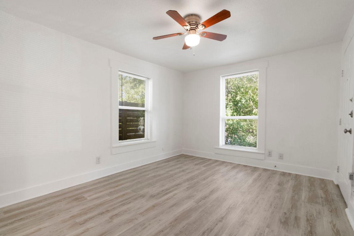 1606 Maple Avenue Austin, TX 78702 - Photo 6 of 15 an empty room with wooden floor and windows