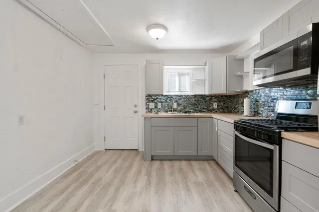 a kitchen with a refrigerator stove and sink