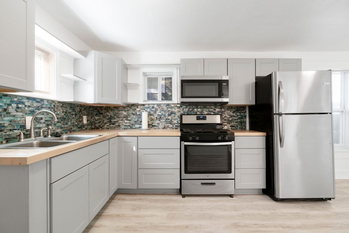 1606 Maple Avenue Austin, TX 78702 - Photo 10 of 15 a kitchen with a refrigerator stove and sink