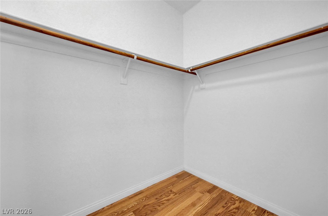 977 Sparkling Light Street Henderson, NV 89052 - Photo 48 of 75 This spacious closet features ample hanging space and attractive hardwood flooring.