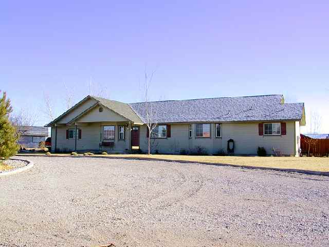 4046 Cimarron Road, Unit 1 Fallon, NV 89406 - Photo 1 of 6 a front view of a house with a yard