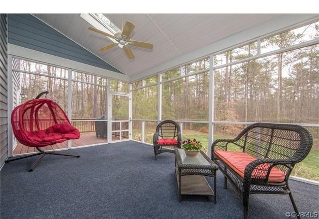 14313 Princess Mary Road Chesterfield, VA 23838 - Photo 36 of 48 a living room with furniture a floor to ceiling window and a table
