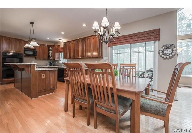 14313 Princess Mary Road Chesterfield, VA 23838 - Photo 7 of 48 a view of a dining room with furniture wooden floor and chandelier