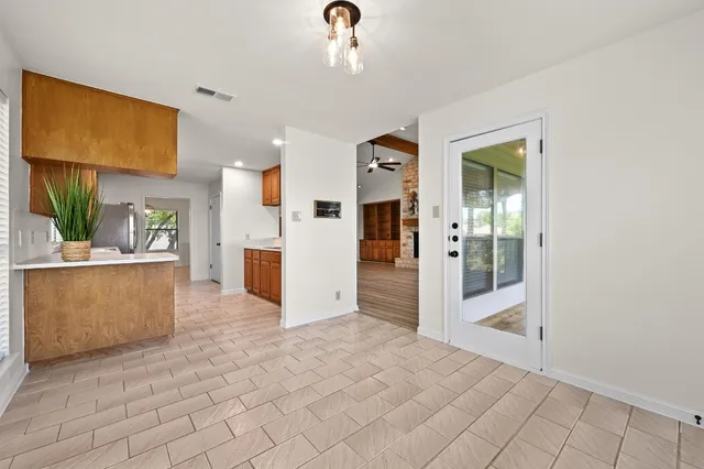 a view of a kitchen with furniture and an empty room