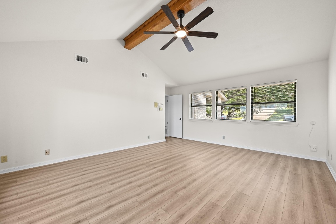3510 Native Dancer Cove Austin, TX 78746 - Photo 17 of 35 an empty room with wooden floor fan and windows