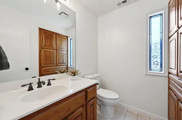 a bathroom with a sink a toilet and mirror