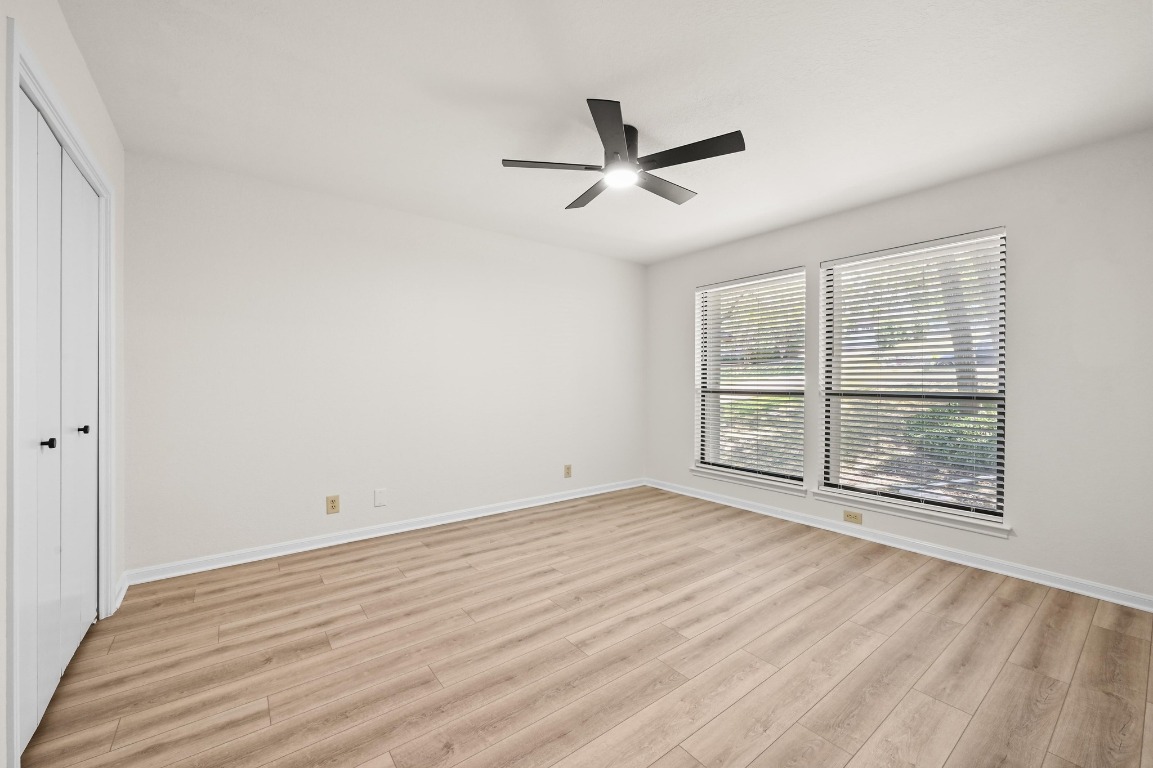 3510 Native Dancer Cove Austin, TX 78746 - Photo 21 of 35 an empty room with wooden floor and windows
