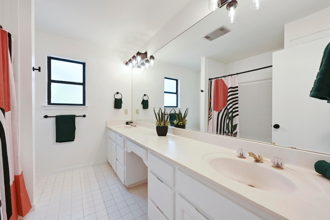 3510 Native Dancer Cove Austin, TX 78746 - Photo 24 of 35 a spacious bathroom with a sinks a vanity and a mirror