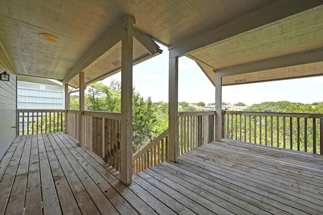 a view of a wooden deck with a yard