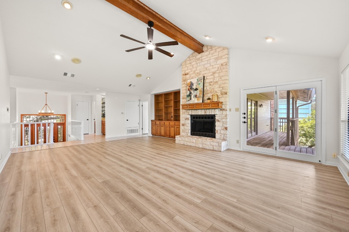 3510 Native Dancer Cove Austin, TX 78746 - Photo 7 of 35 a view of an empty room with wooden floor and a fireplace