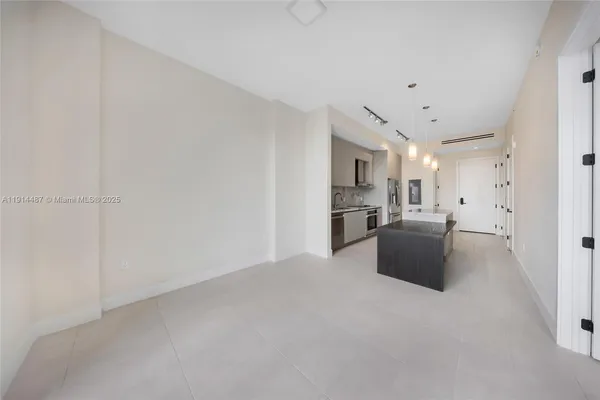 a kitchen with stainless steel appliances a refrigerator sink and stove
