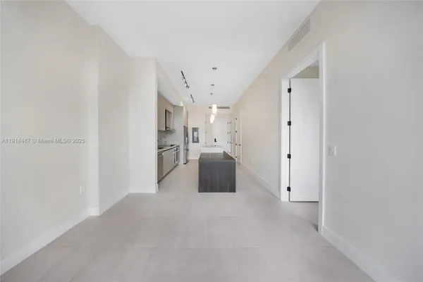 a kitchen with stainless steel appliances granite countertop white cabinets and white appliances