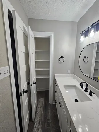 a bathroom with a sink a mirror and a toilet