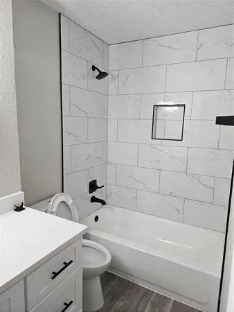 a bathroom with a toilet a sink and bathtub