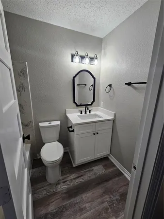 a bathroom with a sink toilet and mirror