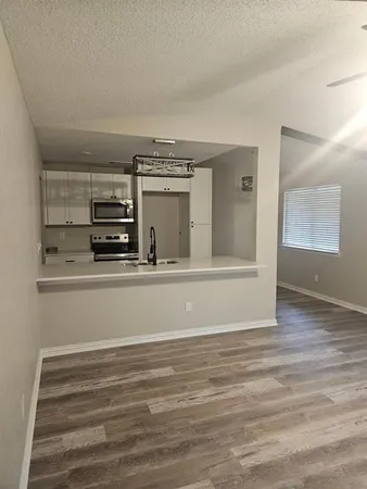 a view of kitchen and empty room