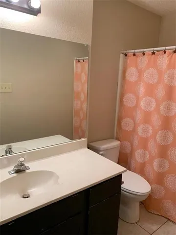 a bathroom with a toilet and a bath tub