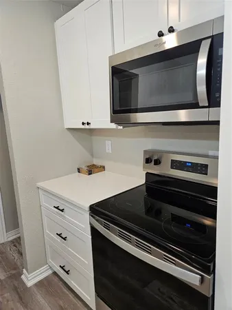 a kitchen with appliances and cabinets