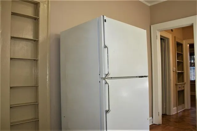 a view of walk in closet with empty racks