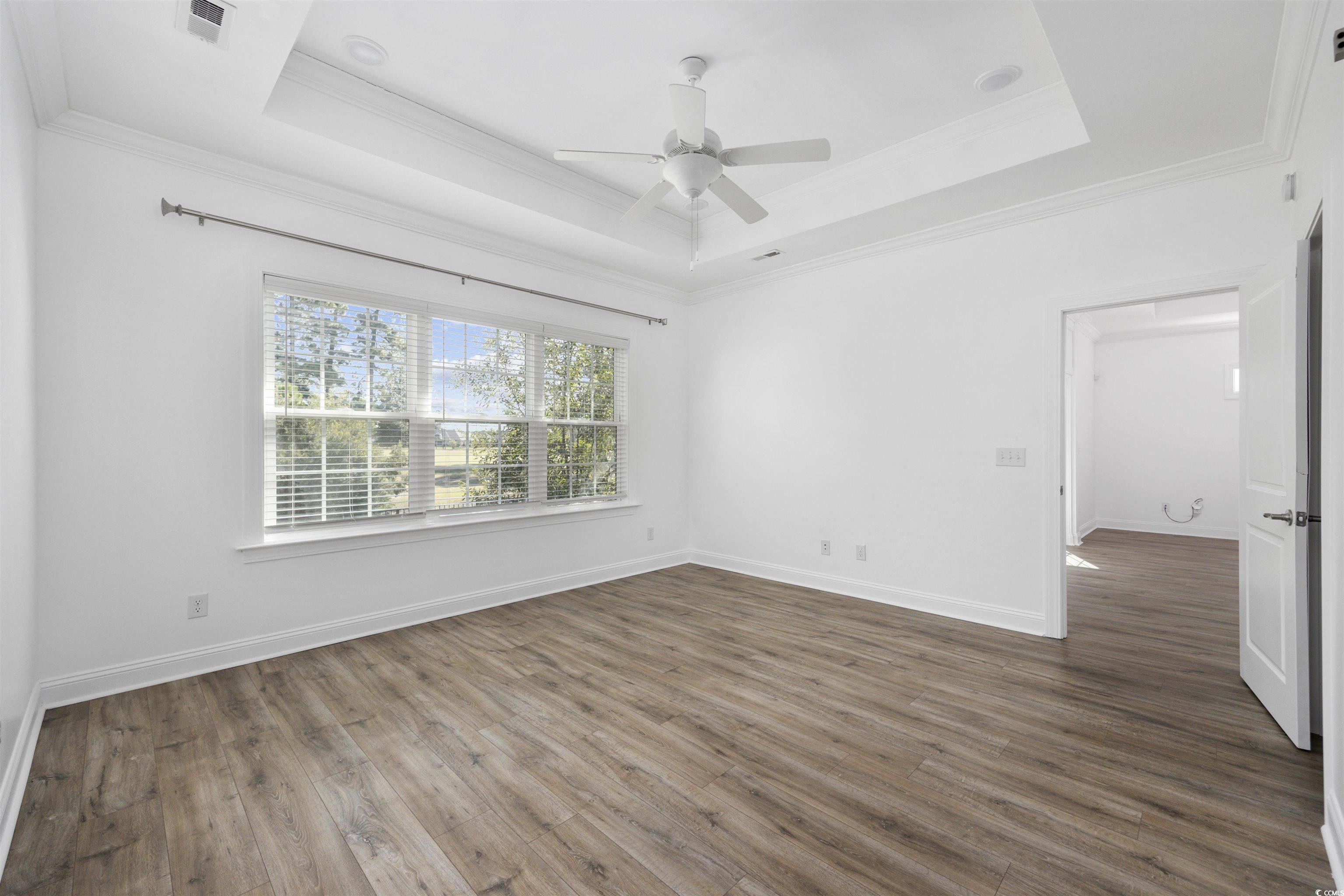 1108 Pochard Drive Conway, SC 29526 - Photo 19 of 37 Unfurnished bedroom featuring a tray ceiling, wood finished floors, ornamental molding, and ceiling fan