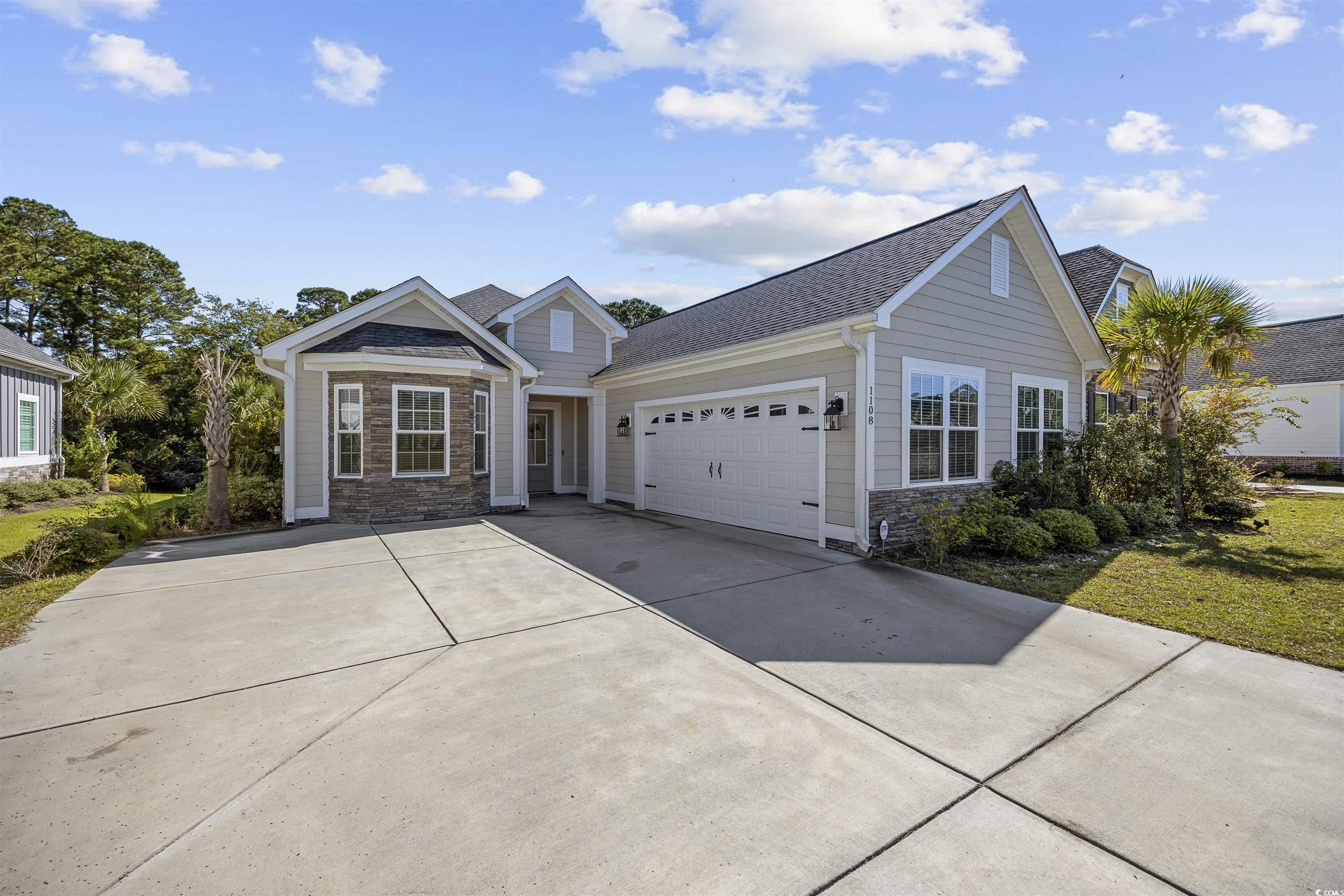 1108 Pochard Drive Conway, SC 29526 - Photo 2 of 37 View of front of home featuring stone siding, concrete driveway, a garage, and a shingled roof