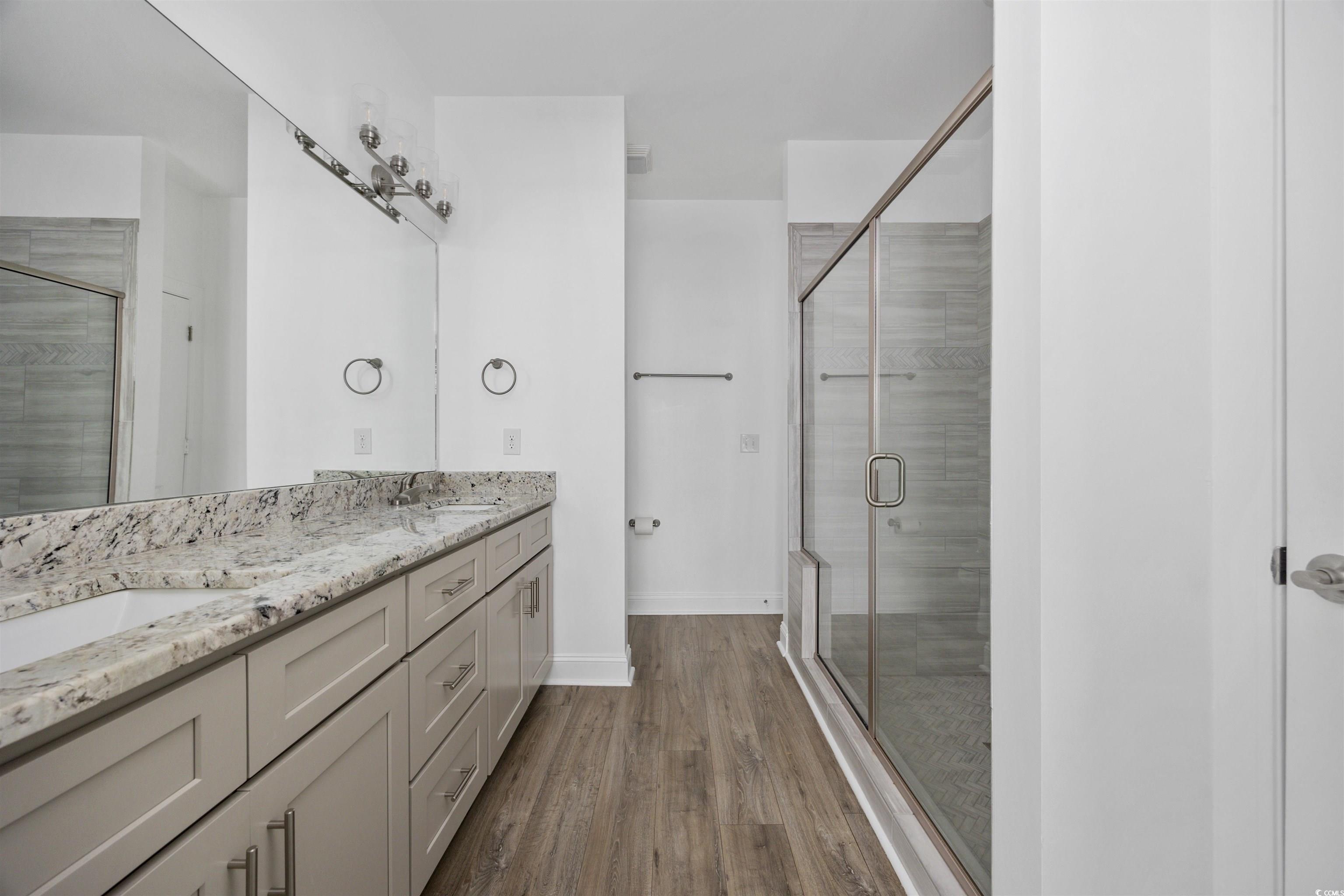 1108 Pochard Drive Conway, SC 29526 - Photo 21 of 37 Bathroom featuring a stall shower, double vanity, and dark wood-style floors