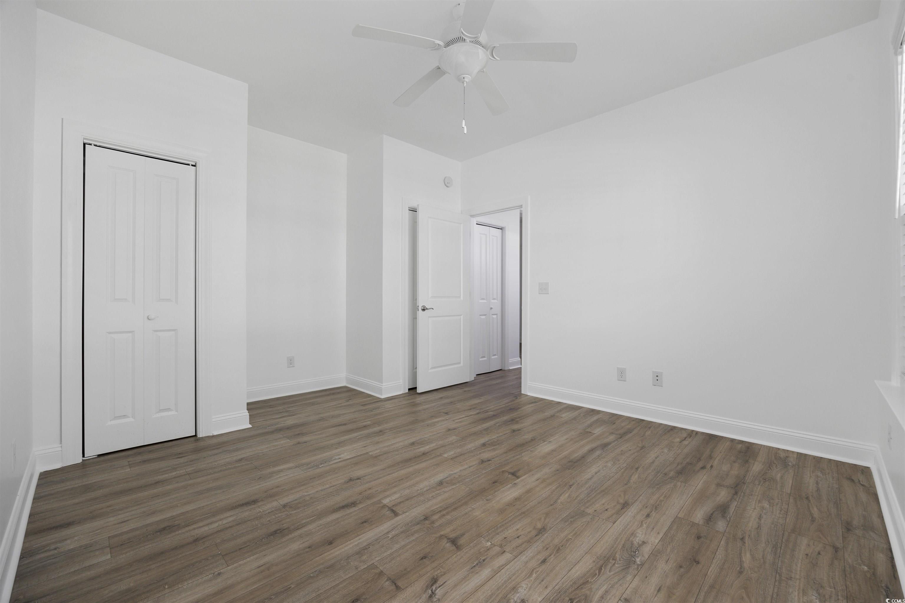 1108 Pochard Drive Conway, SC 29526 - Photo 23 of 37 Unfurnished bedroom featuring dark wood-style flooring, a ceiling fan, and a closet