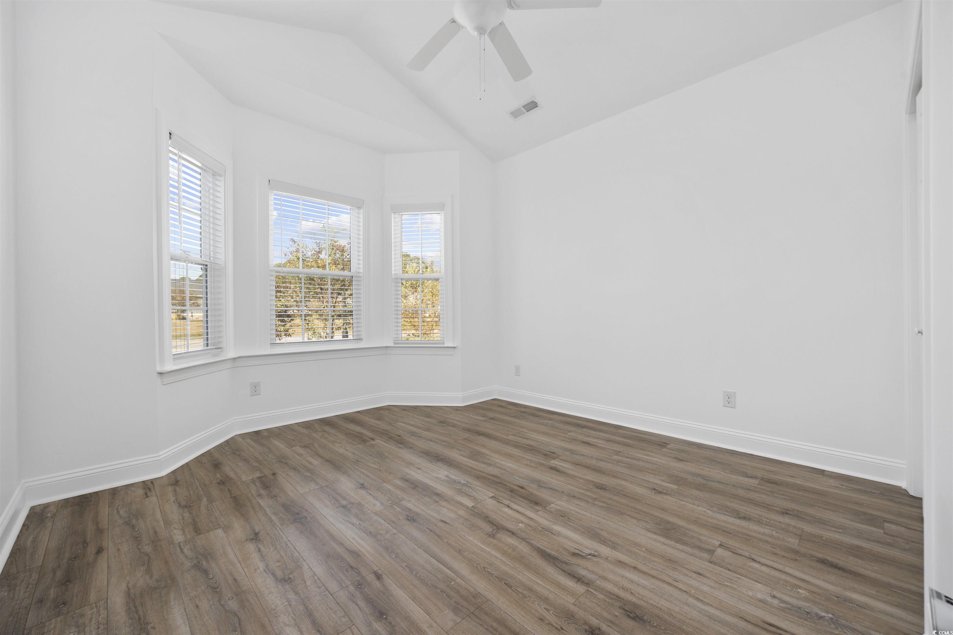 1108 Pochard Drive Conway, SC 29526 - Photo 26 of 37 Empty room featuring dark wood-style flooring, lofted ceiling, and a ceiling fan