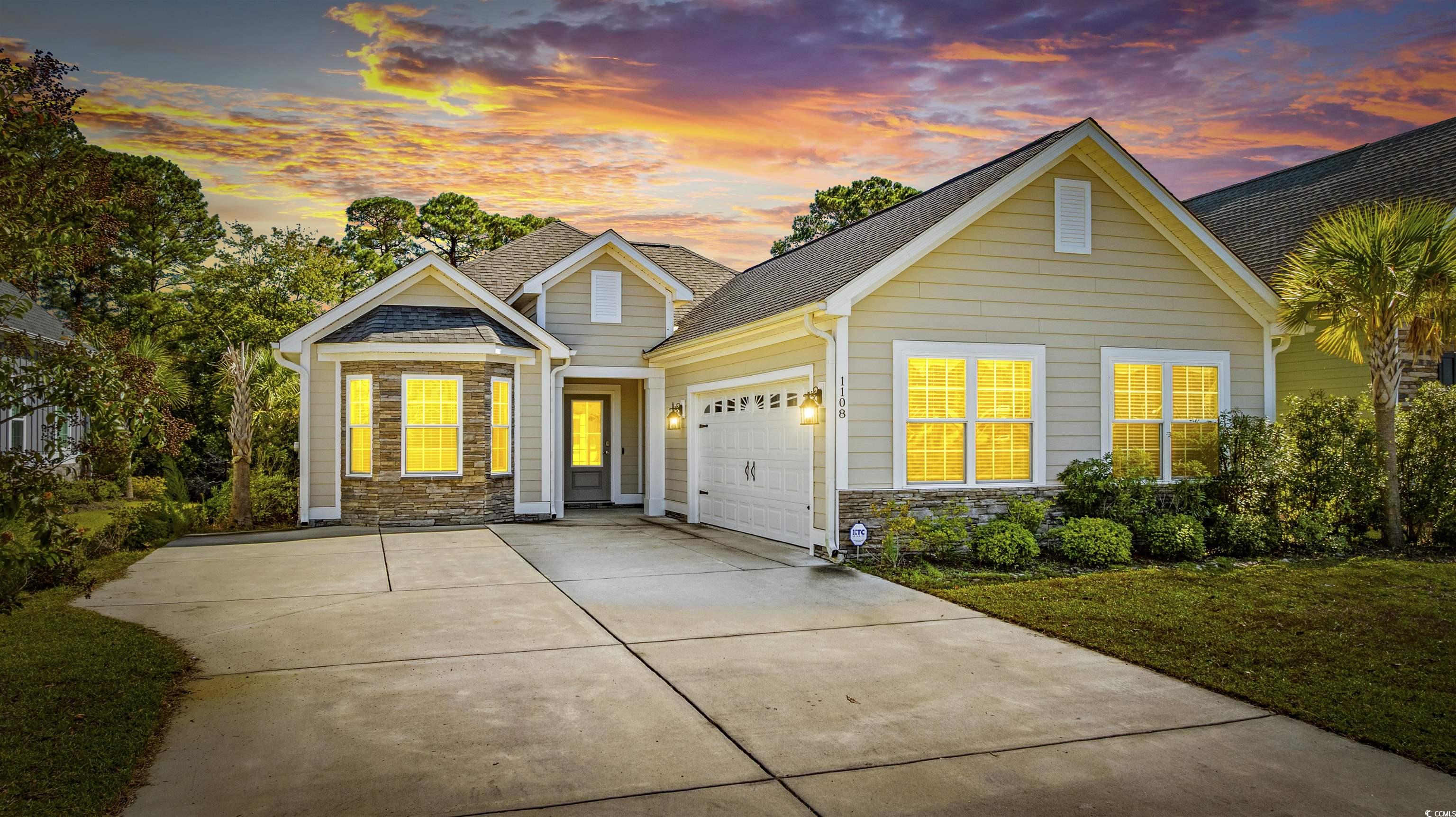 1108 Pochard Drive Conway, SC 29526 - Photo 3 of 37 View of front of home with stone siding, driveway, a garage, roof with shingles, and a front yard