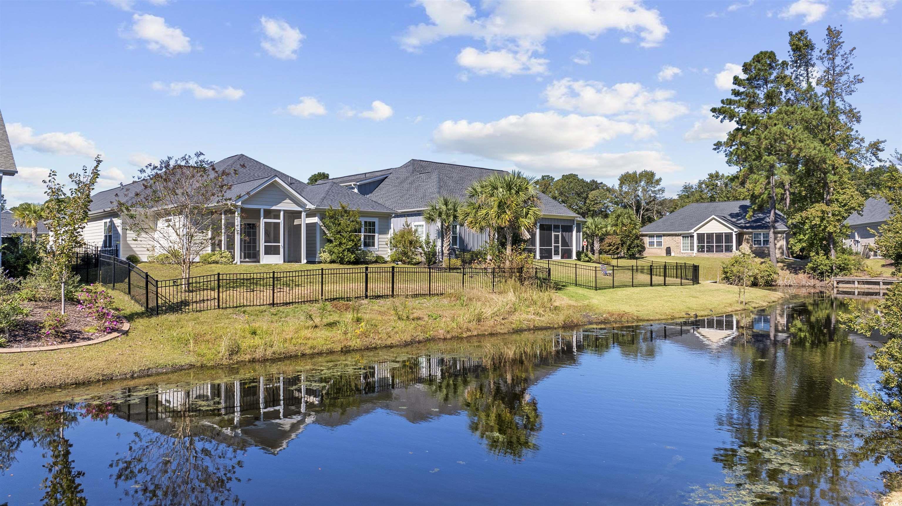 1108 Pochard Drive Conway, SC 29526 - Photo 33 of 37 Back of house with a fenced backyard, a water view, and a sunroom