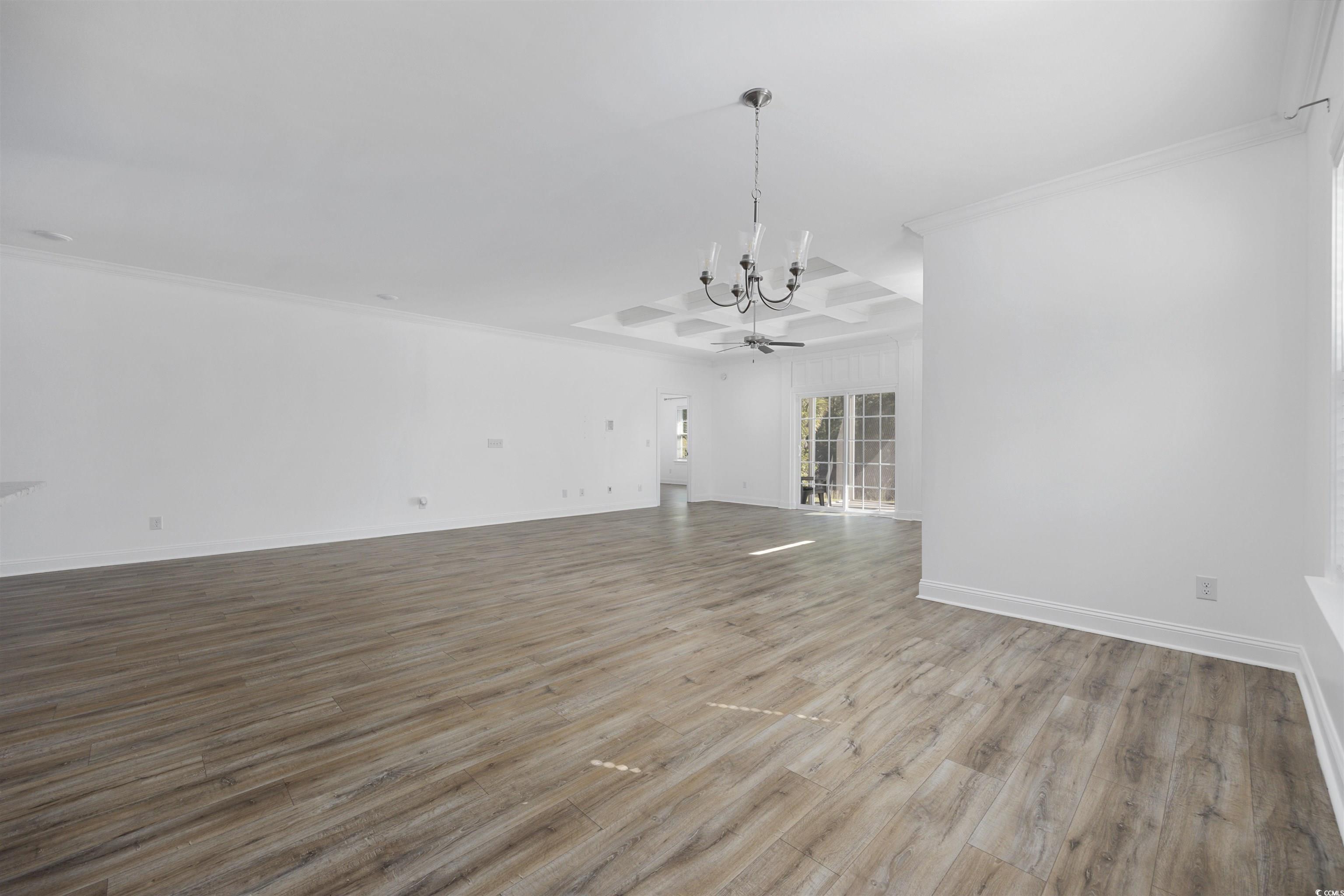1108 Pochard Drive Conway, SC 29526 - Photo 9 of 37 Unfurnished living room with wood finished floors, crown molding, and a chandelier