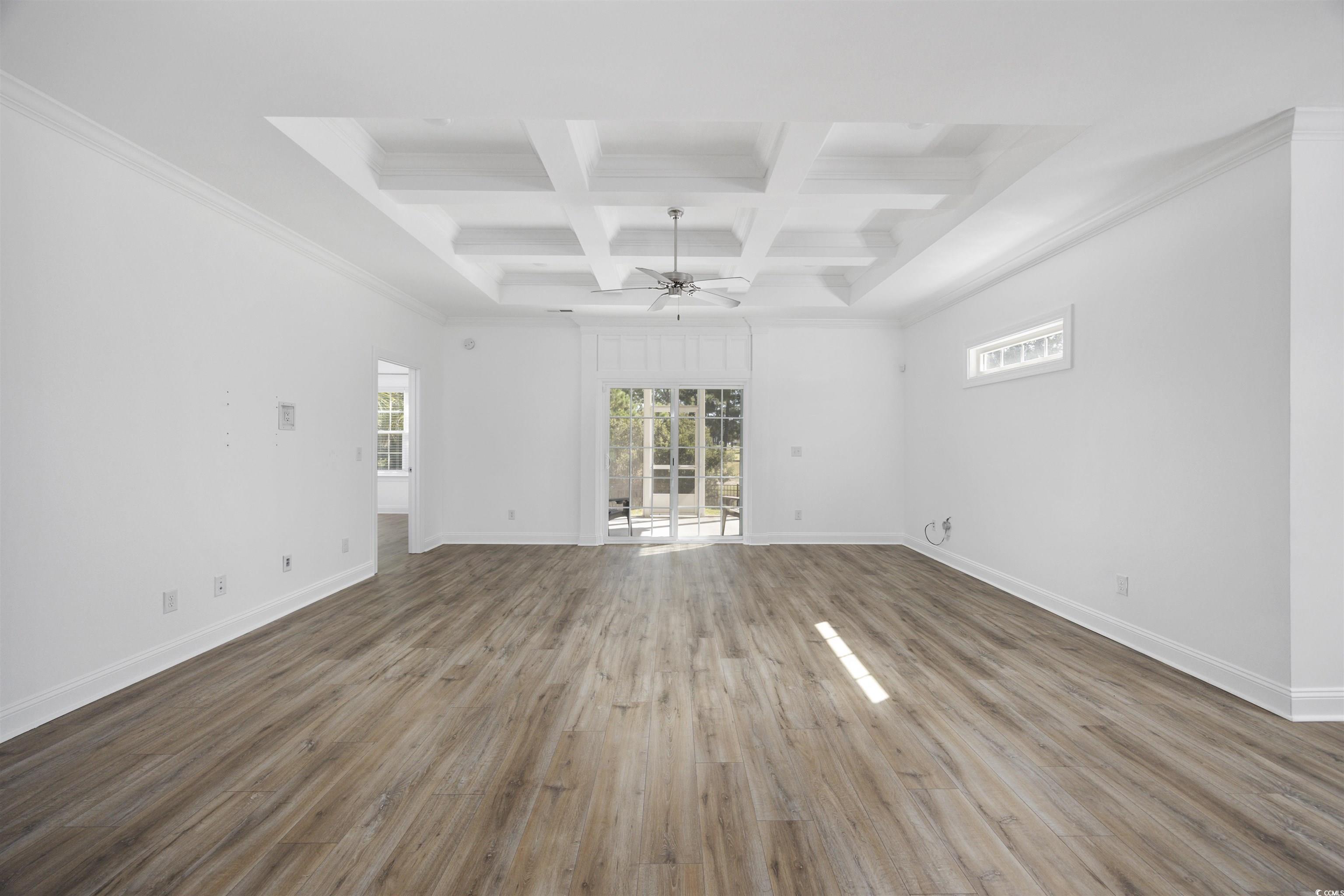1108 Pochard Drive Conway, SC 29526 - Photo 10 of 37 Unfurnished living room featuring coffered ceiling, beam ceiling, healthy amount of natural light, wood finished floors, and ornamental molding