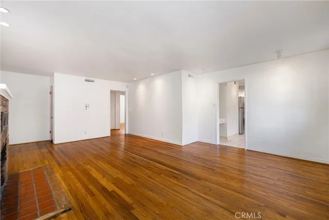 a kitchen with a cabinets a stove a window and a counter space