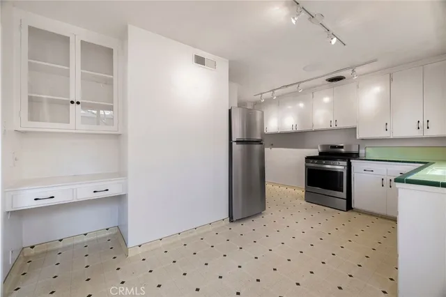 a kitchen with a sink a refrigerator and a stove