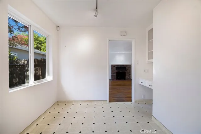 a kitchen with stainless steel appliances a stove a microwave and white cabinets